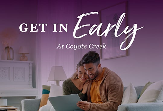 A man and woman looking at a laptop.