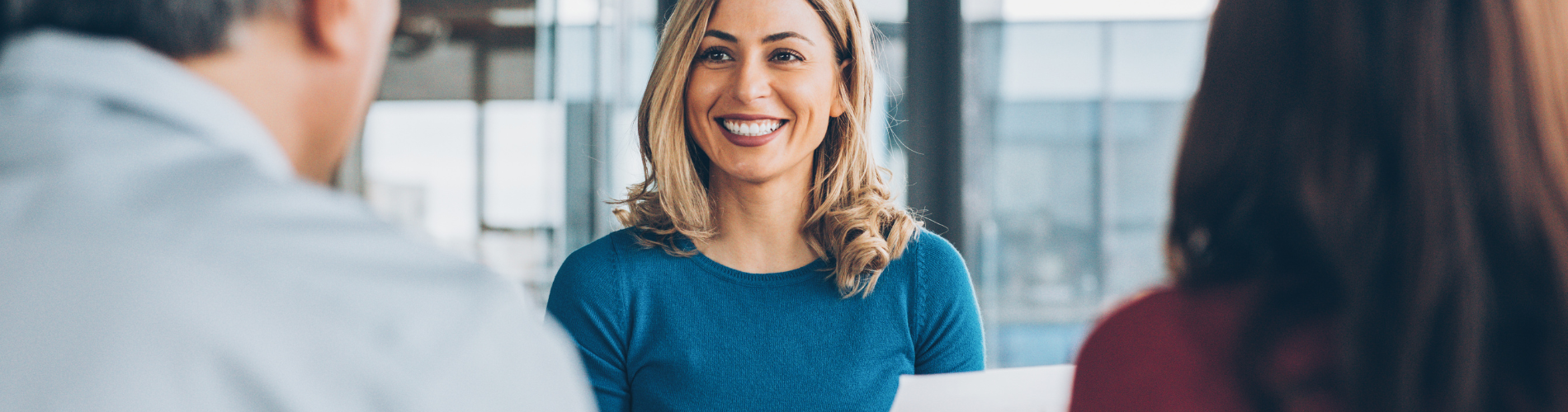 A woman smiling at something.