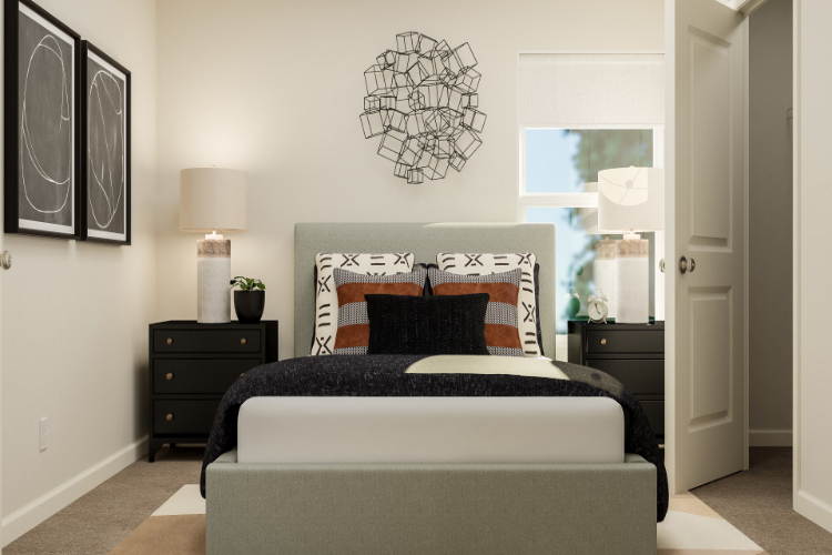 A bedroom with a bed and lamps.