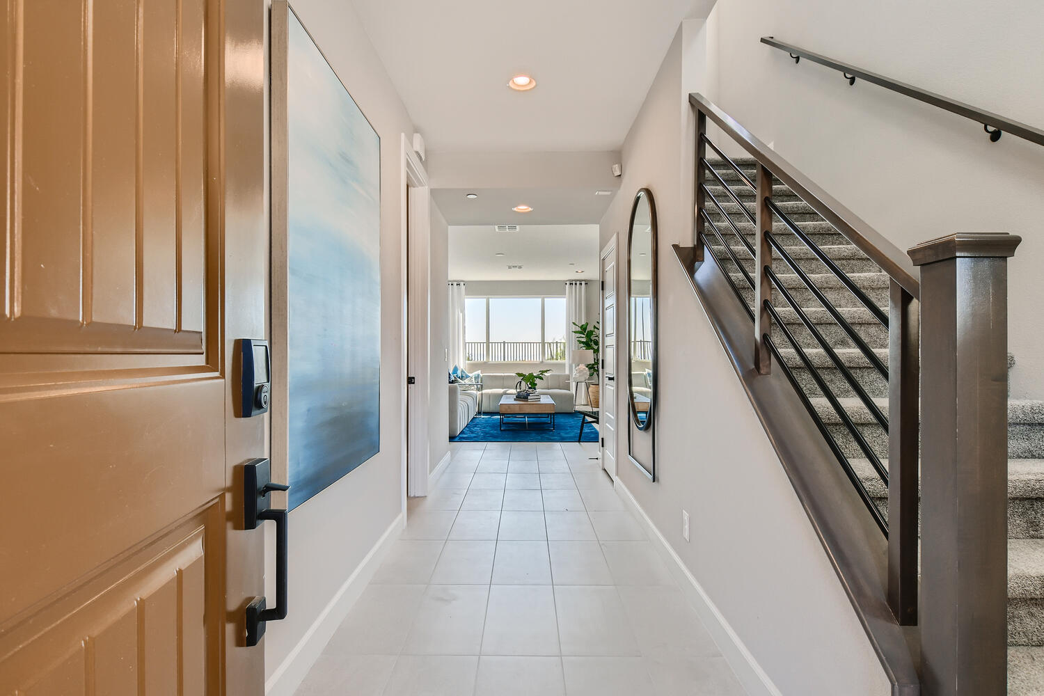 A hallway with wood cabinets.