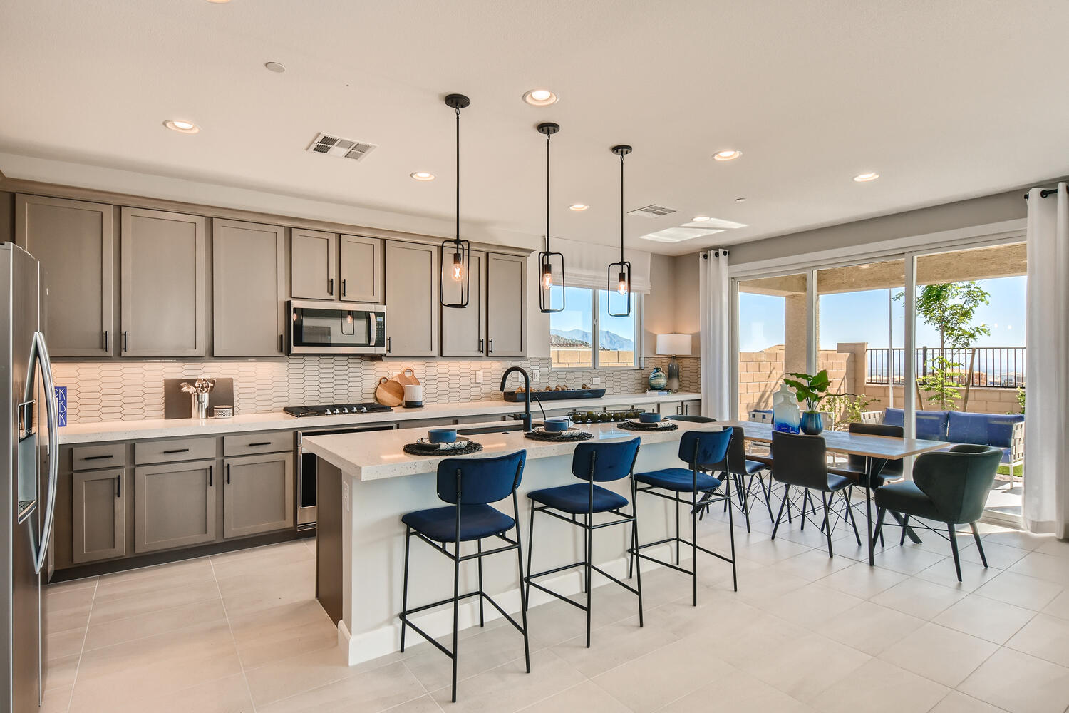 A kitchen with a dining table and chairs.