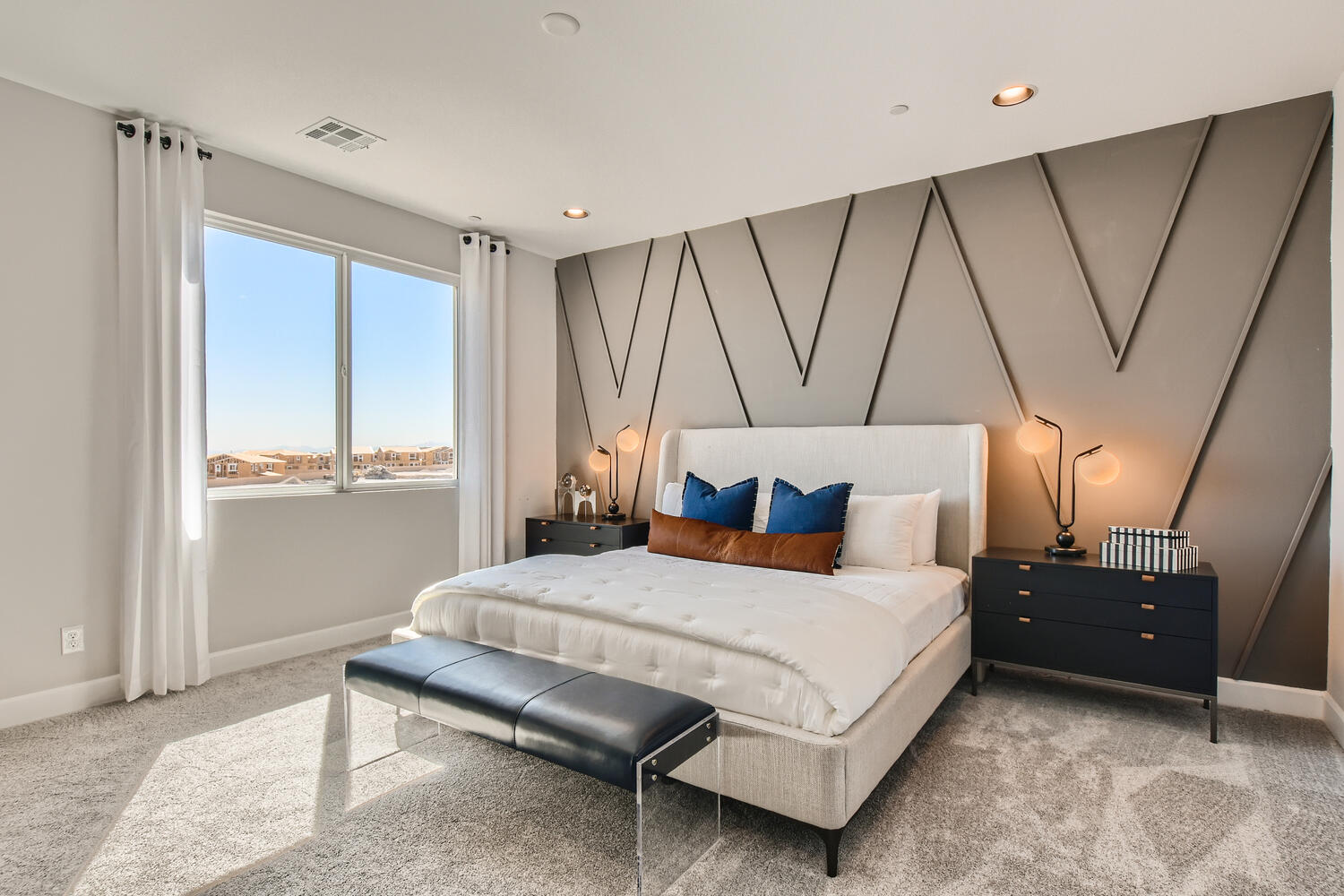 A bedroom with a bed and a couch.