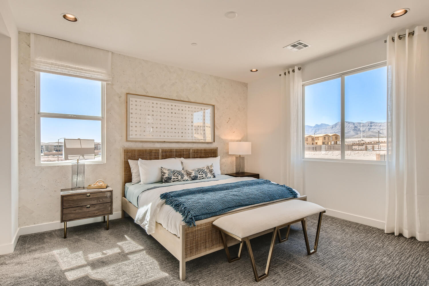 A bedroom with a large window.