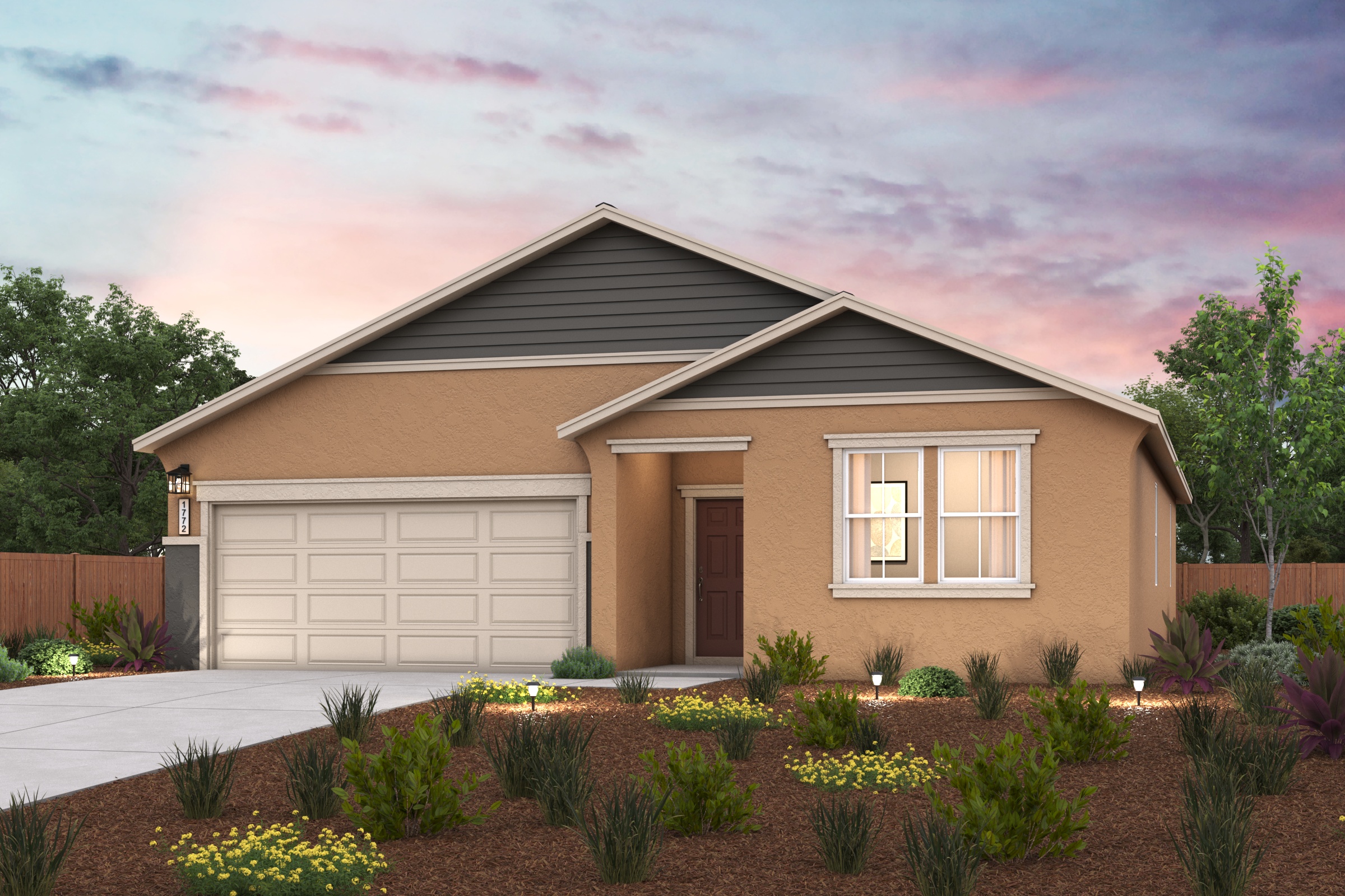 A house with a garage and a garden in front of it.