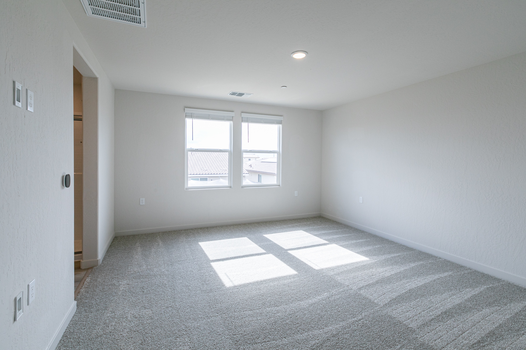 A room with a tile floor and windows.