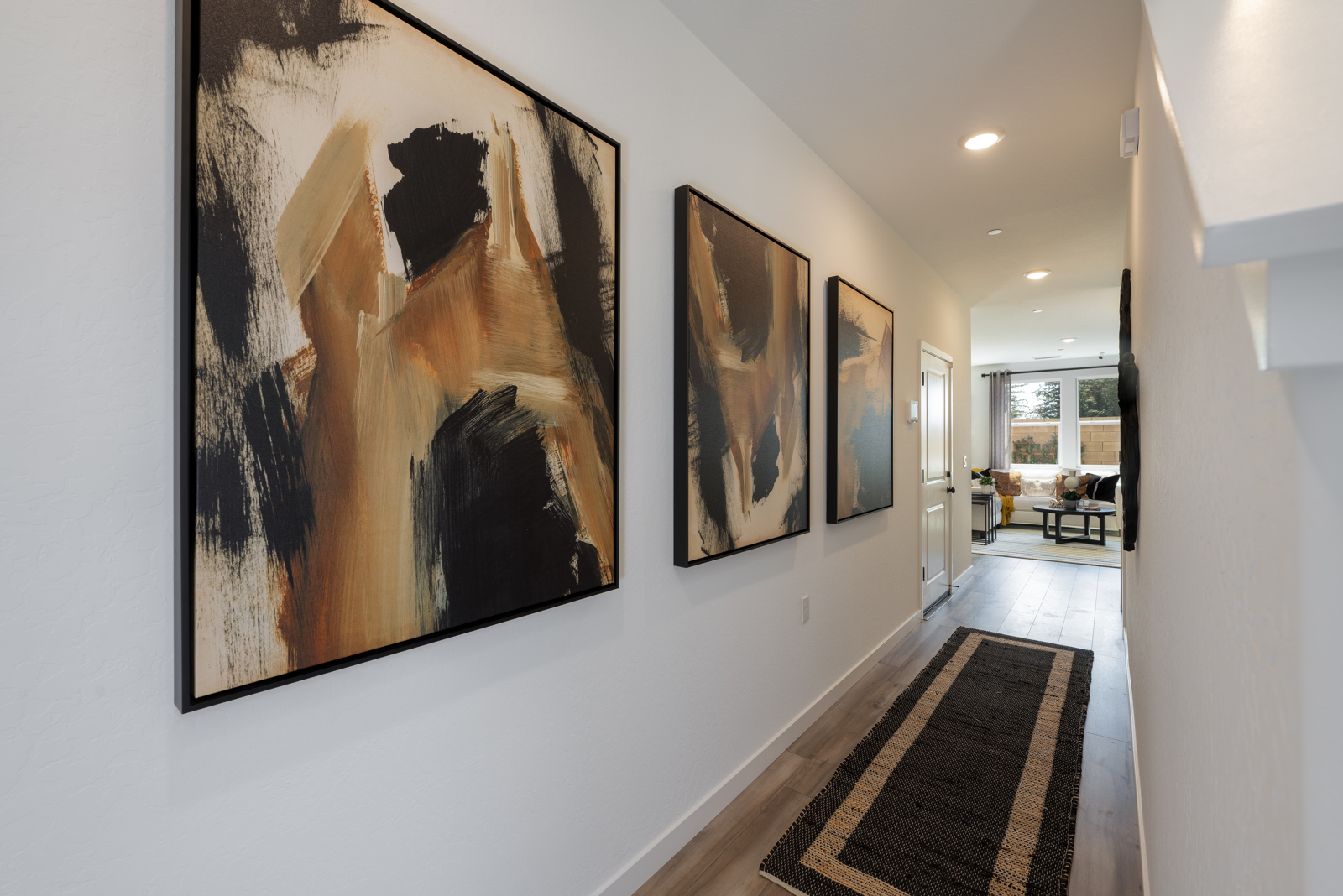 A hallway with art on the wall.