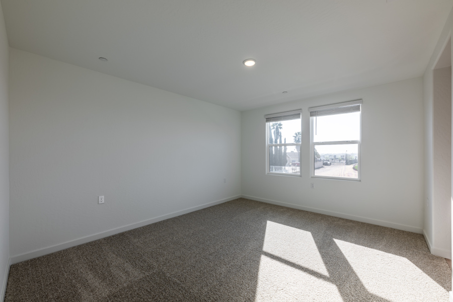 A room with a window and a carpet.