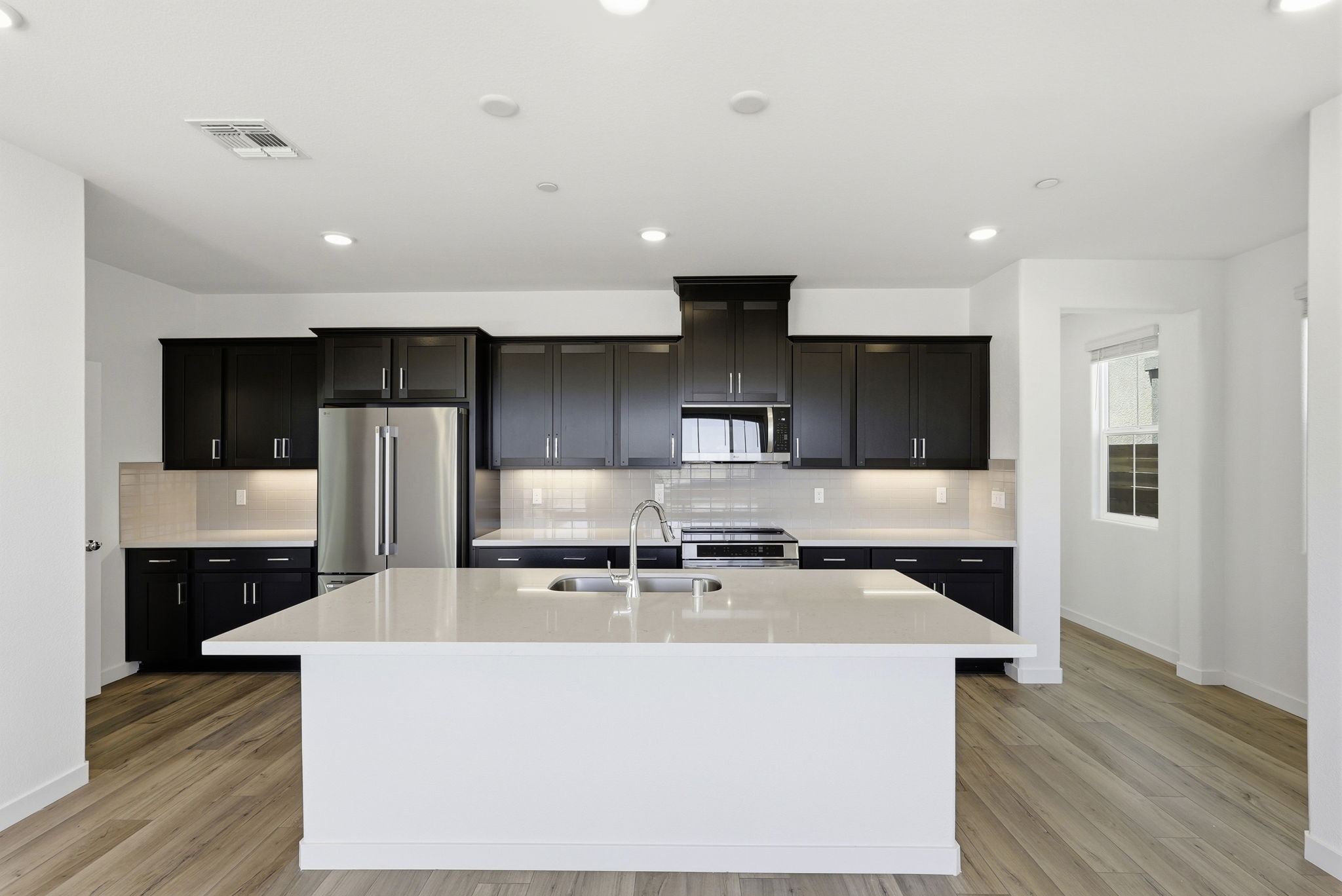 A kitchen with black cabinets.