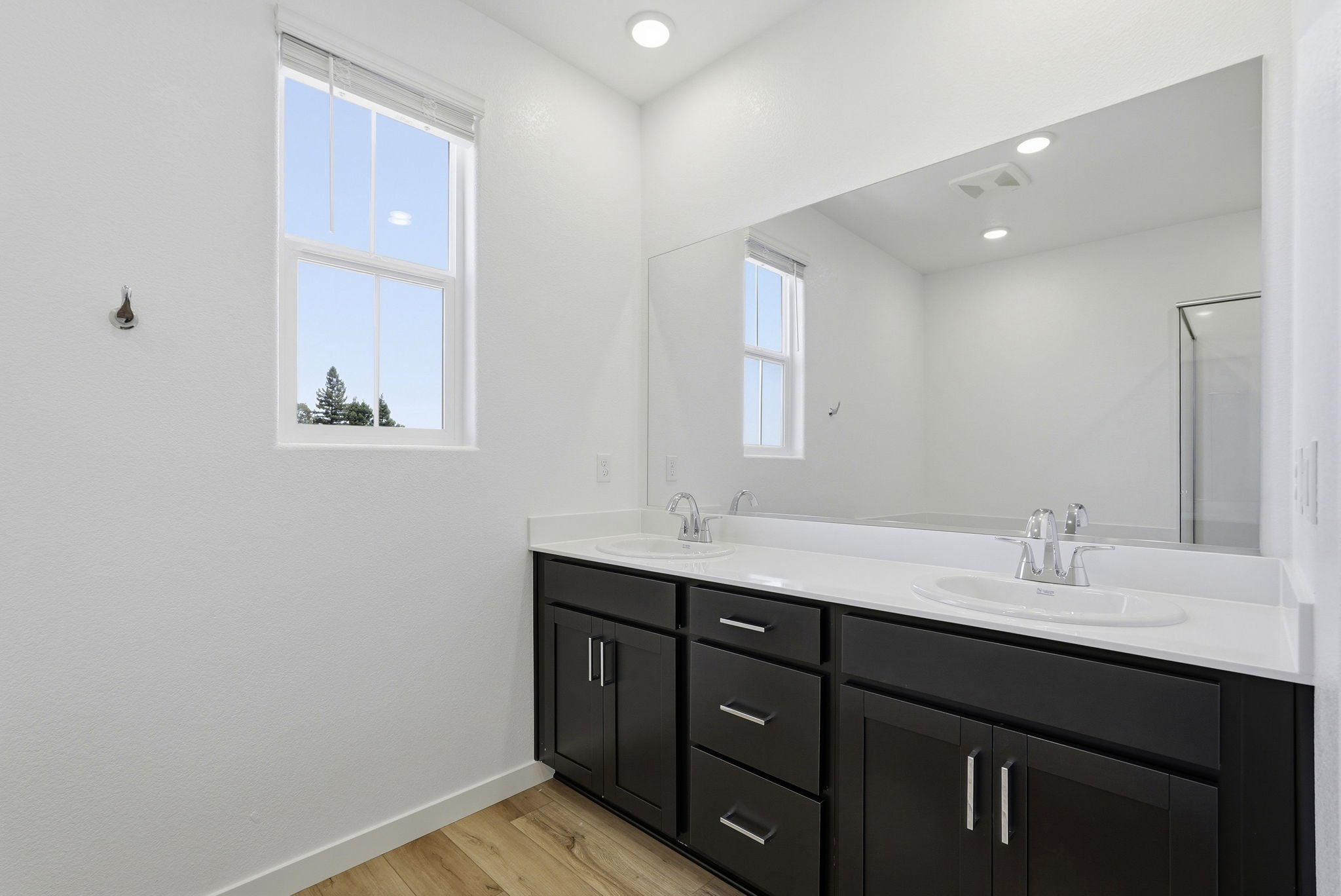 A bathroom with a large mirror.