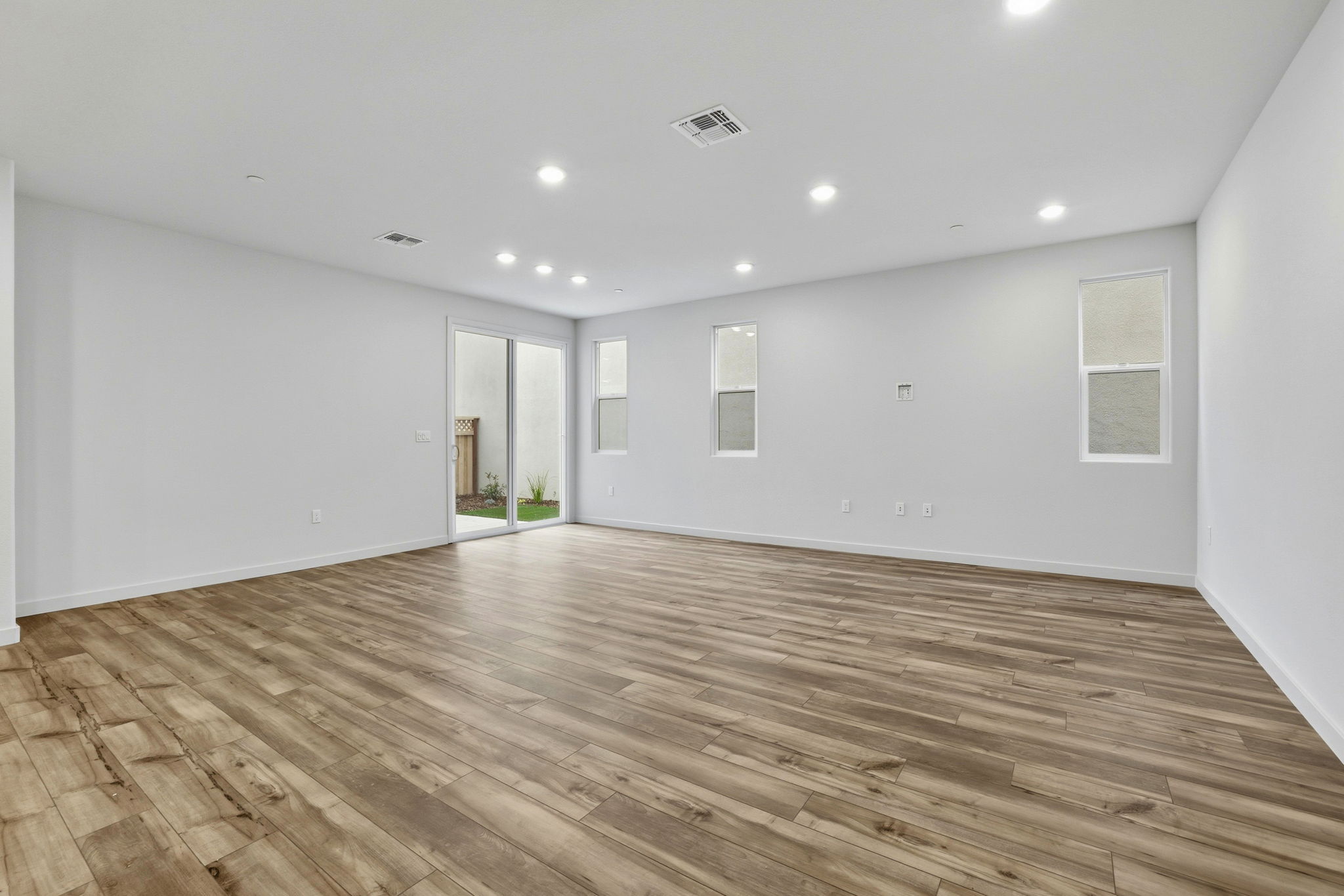 A room with a wood floor and white walls.