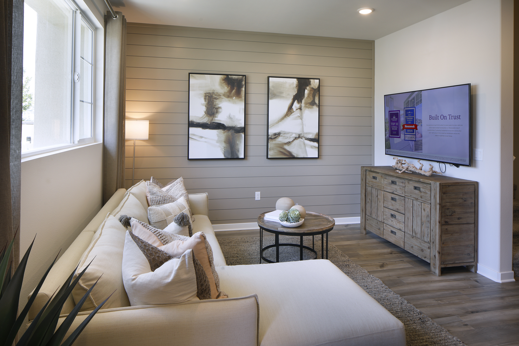 A living room with a couch and a table.