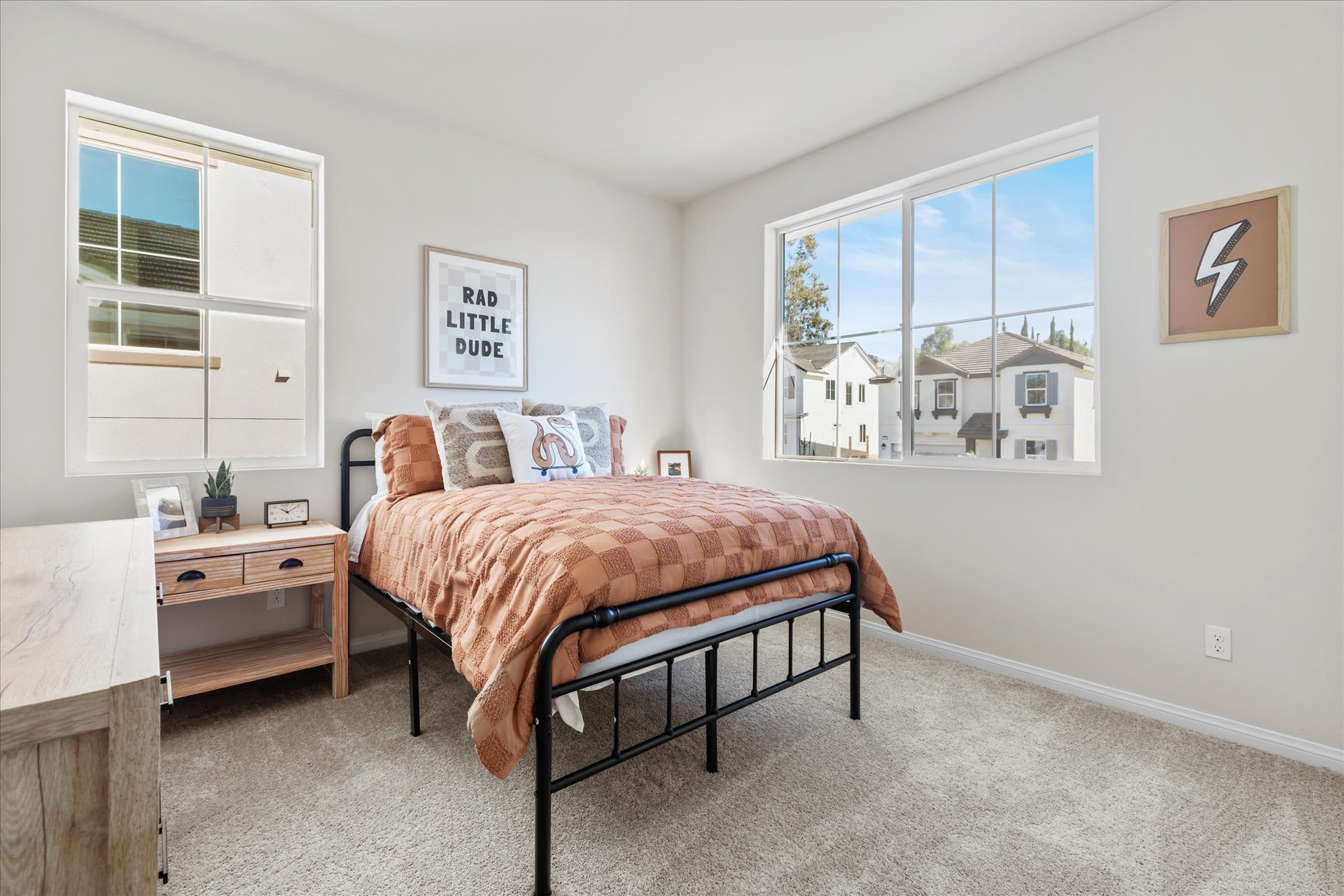 A bedroom with a bed and a bench.