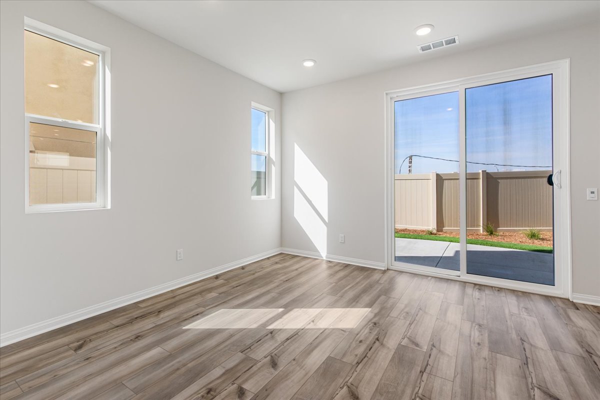 A room with windows and a wood floor.