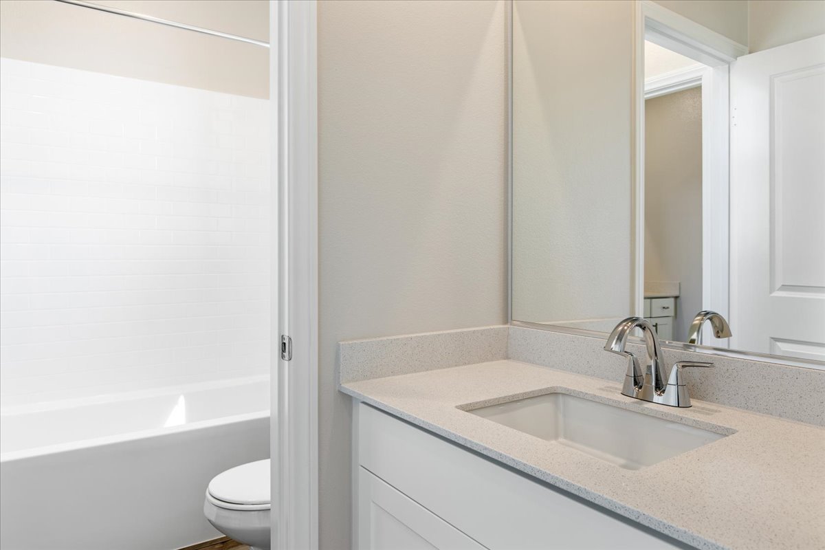 A bathroom with a sink and a toilet.