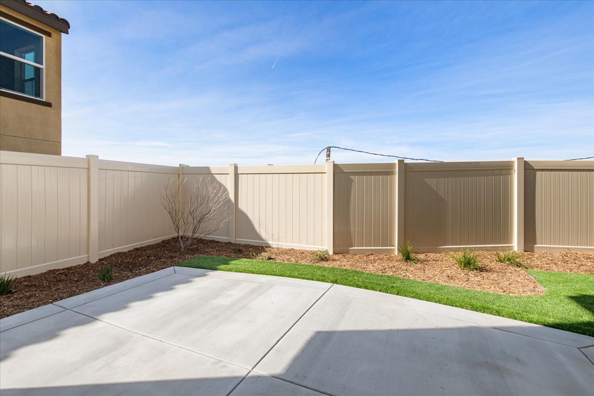 A white fence with a tree in front of it.
