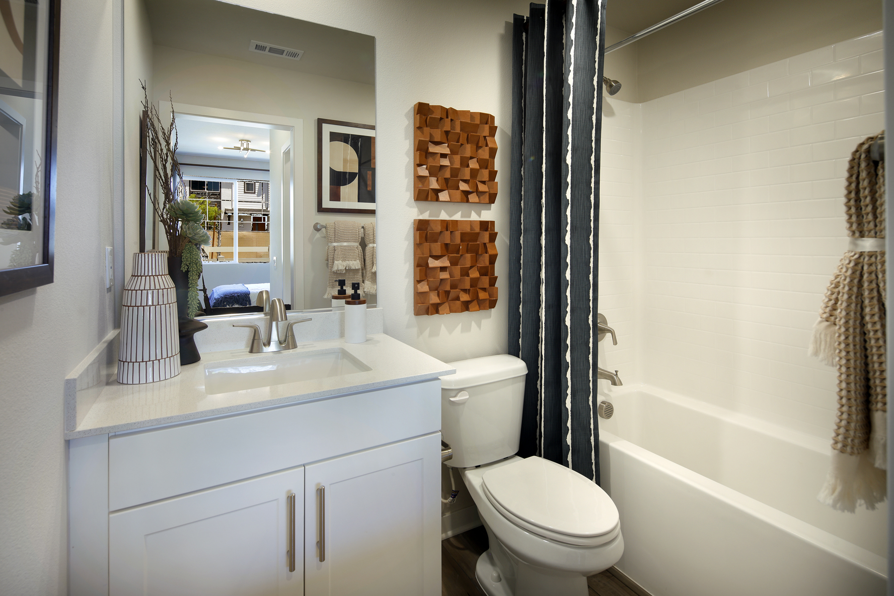 A bathroom with a tub sink and toilet.