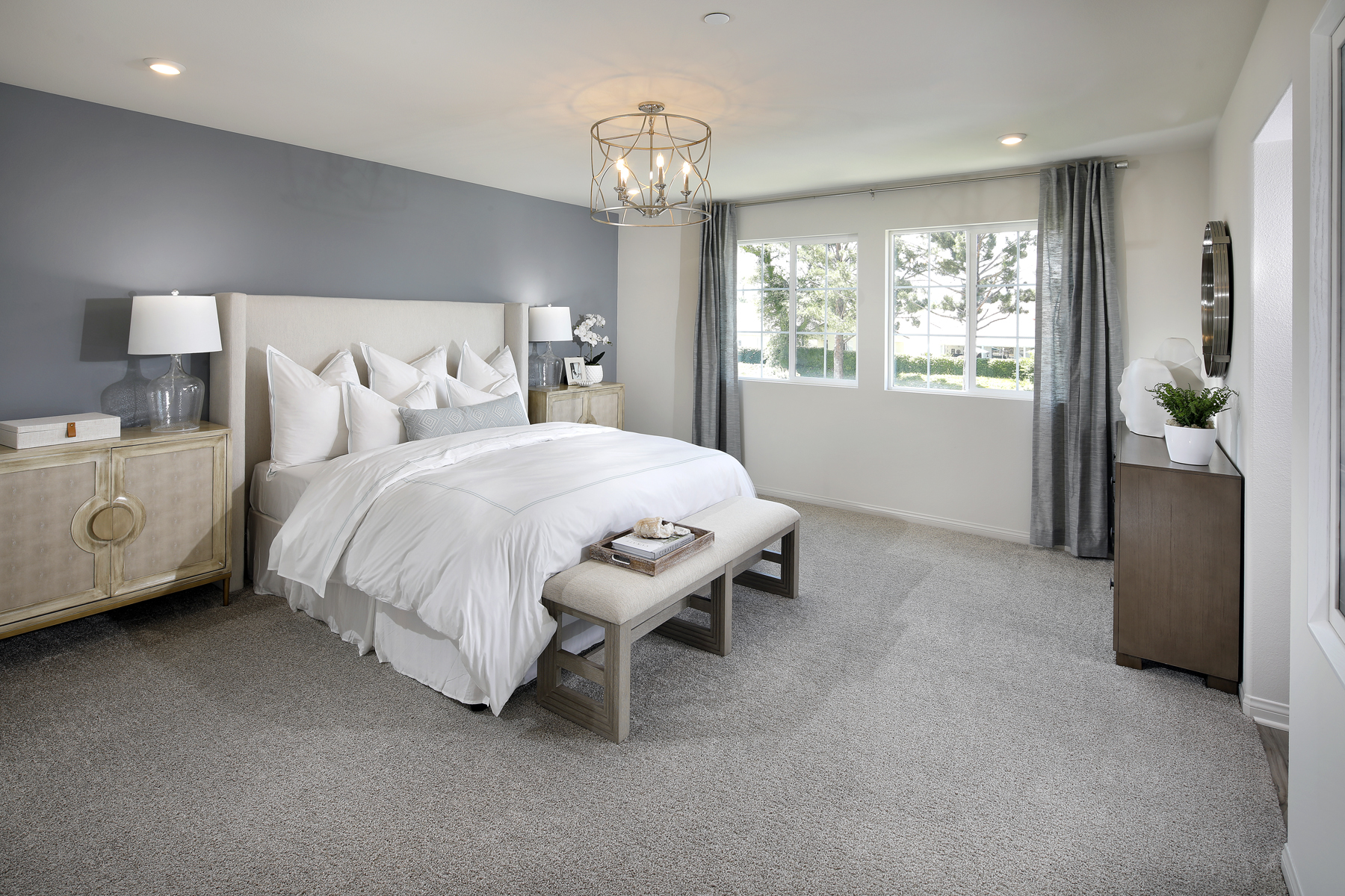 A bedroom with a bed and a bench.