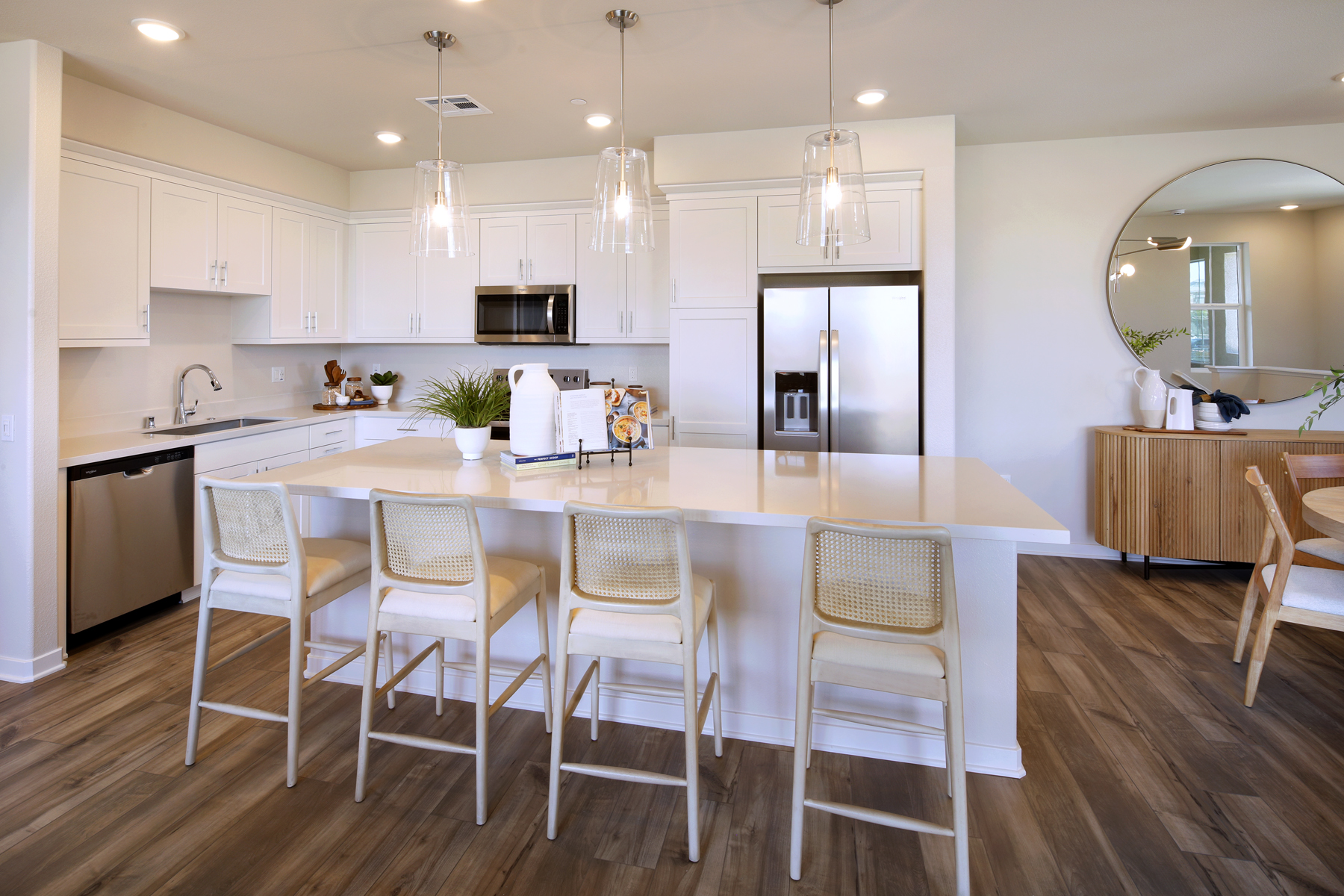 A kitchen with white cabinets.