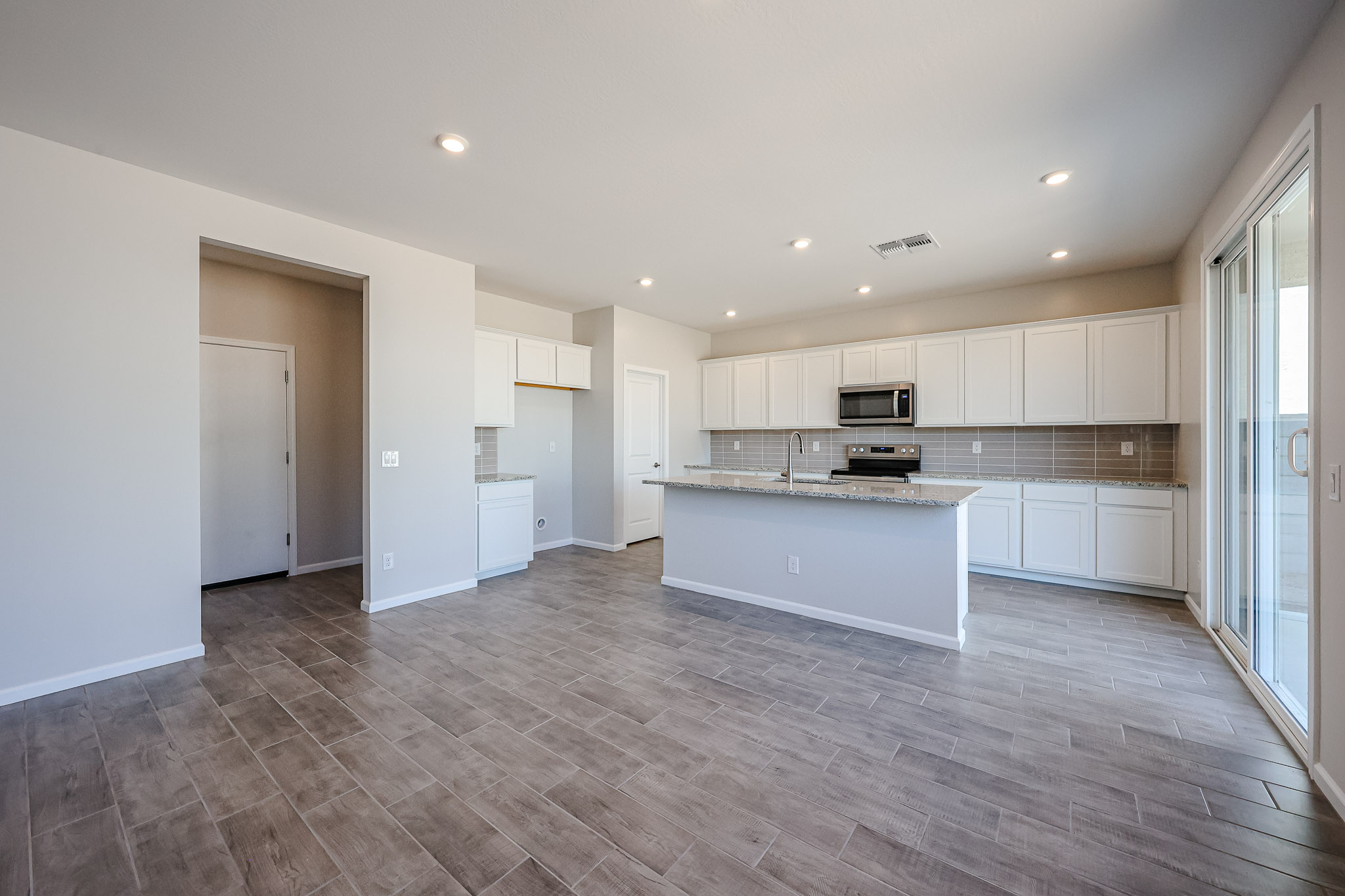 A kitchen with white cabinets.