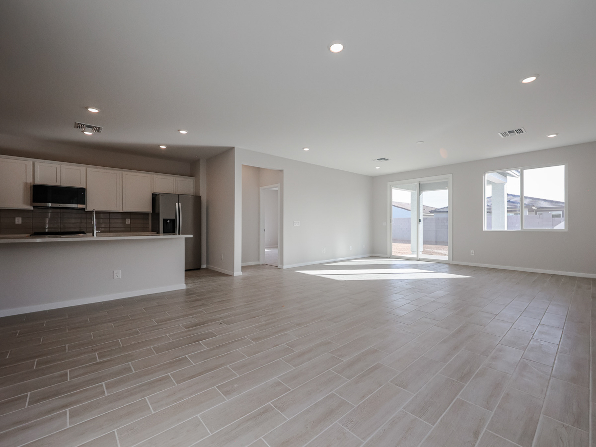 A large empty room with a wood floor and white walls.