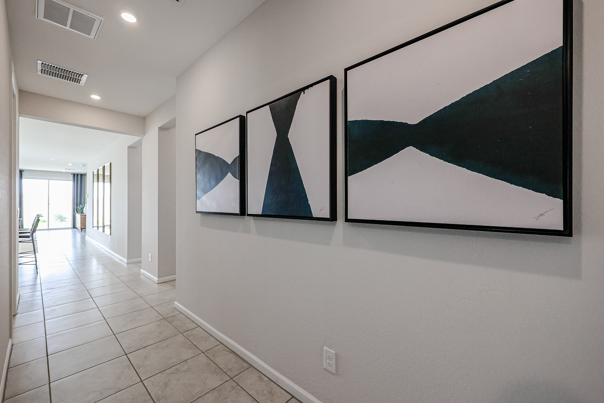 A white wall with a black and white painting on it.