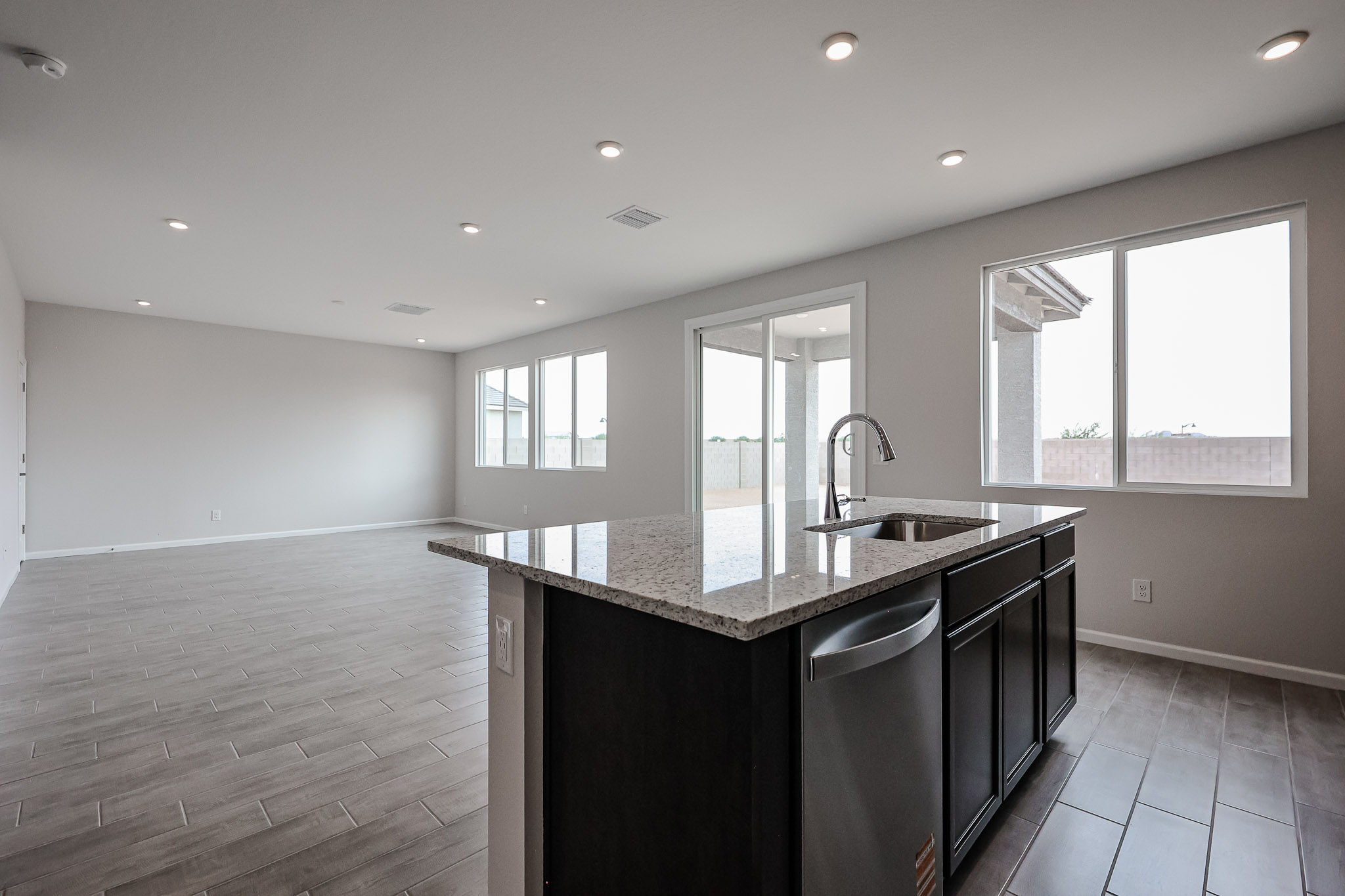 A kitchen with marble counters.