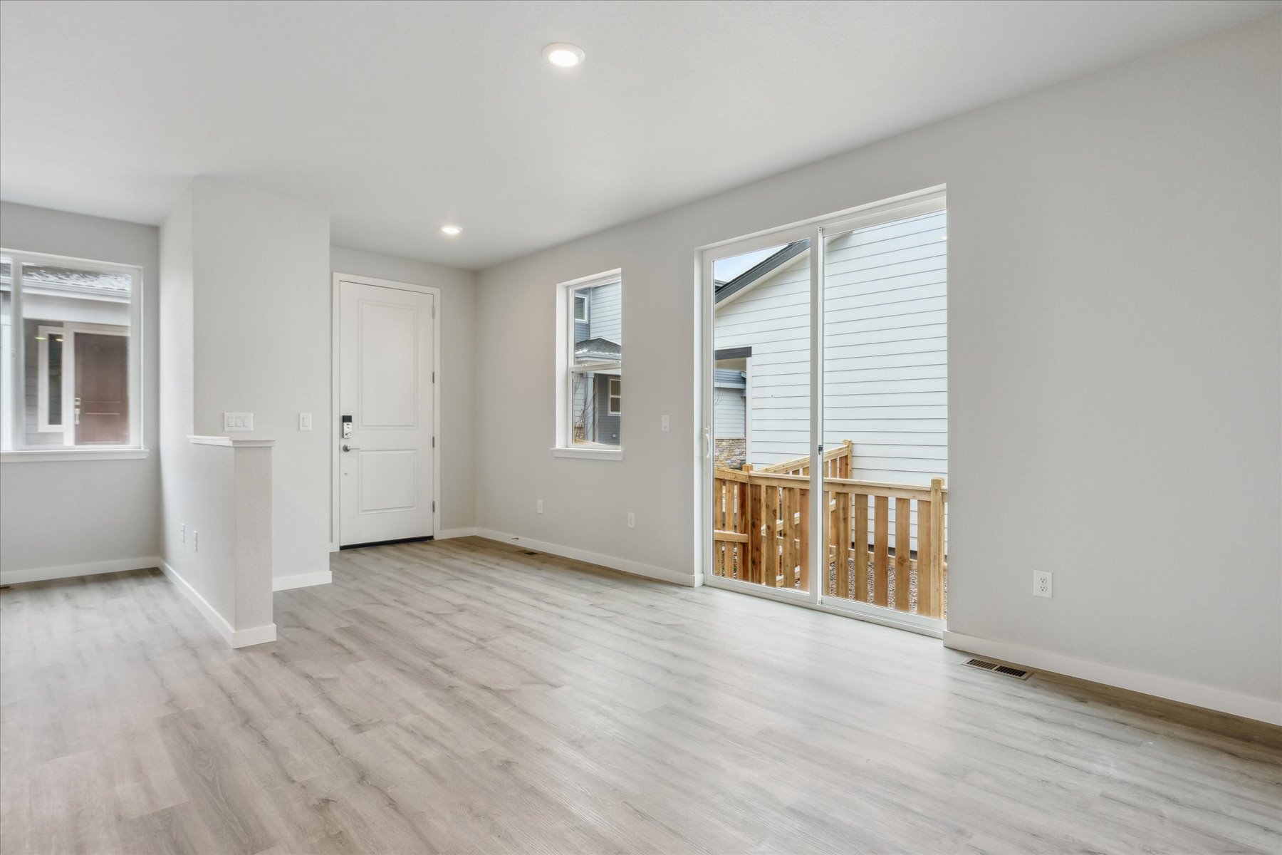 A room with a wood floor and white walls.