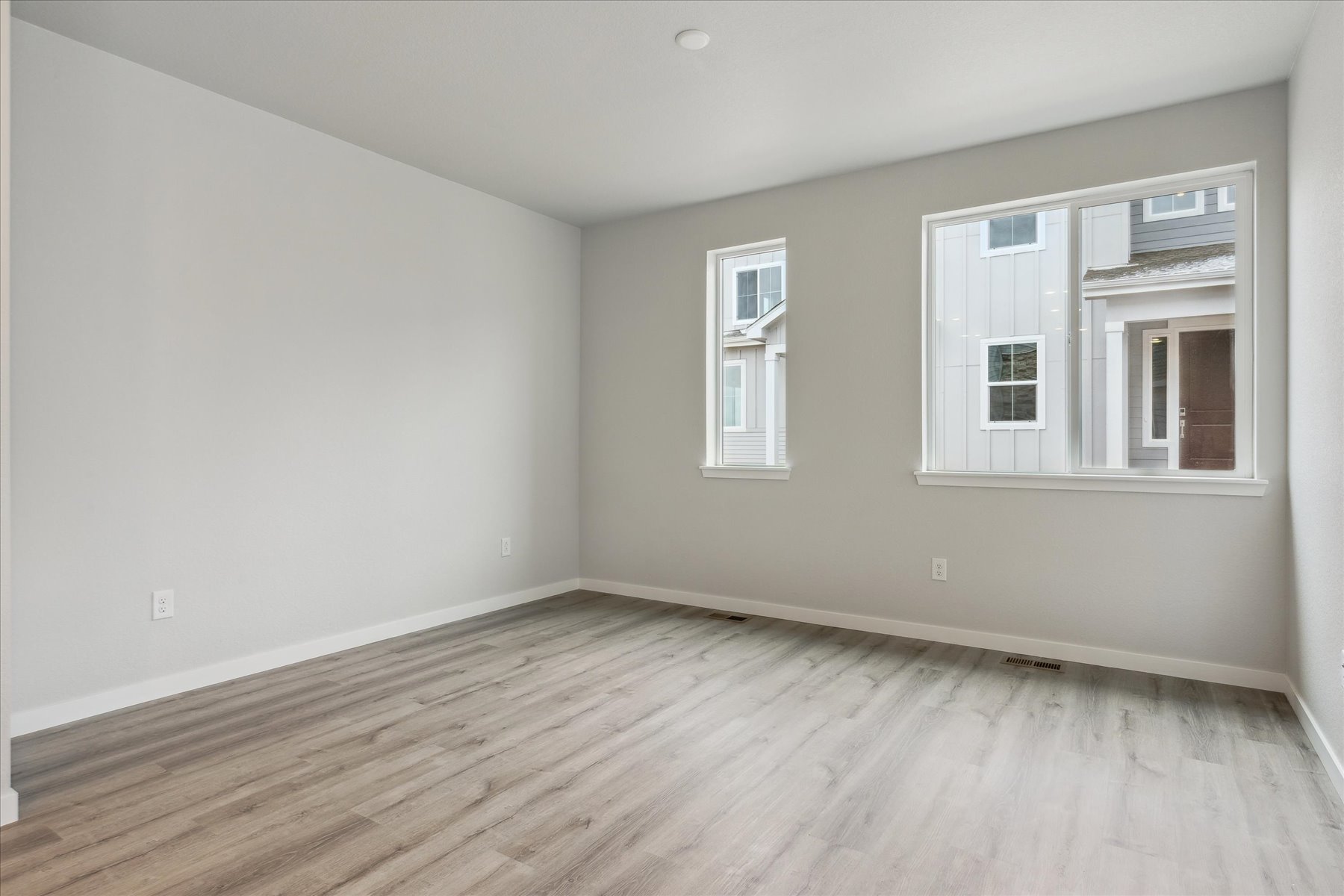 A room with a wood floor and a window.