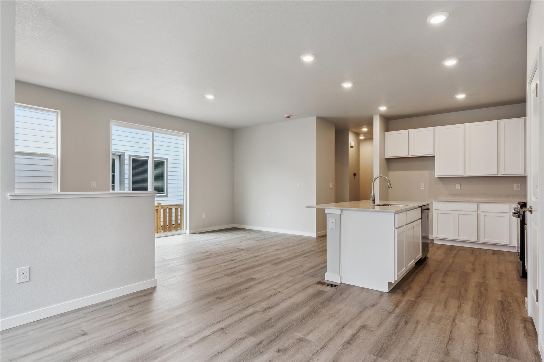 A kitchen with white cabinets.