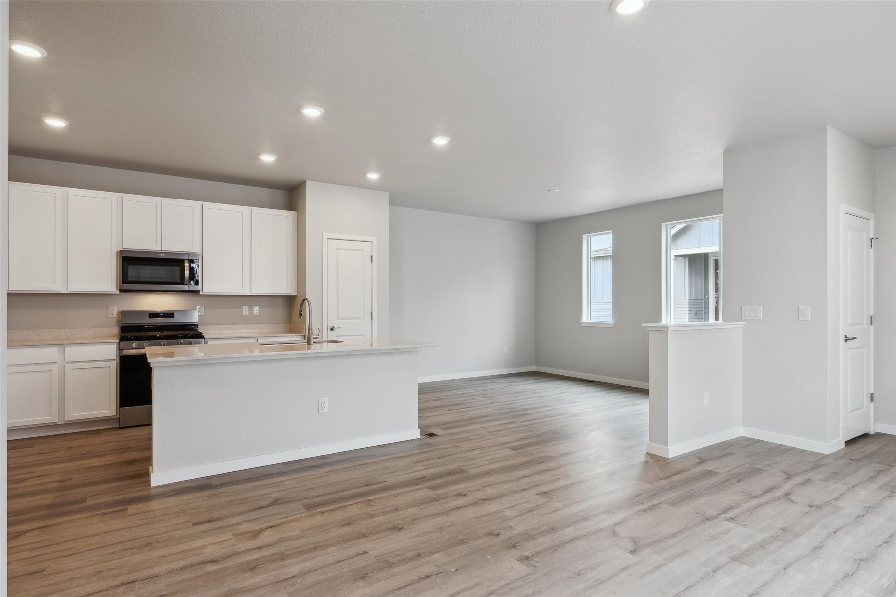 A kitchen with white cabinets.