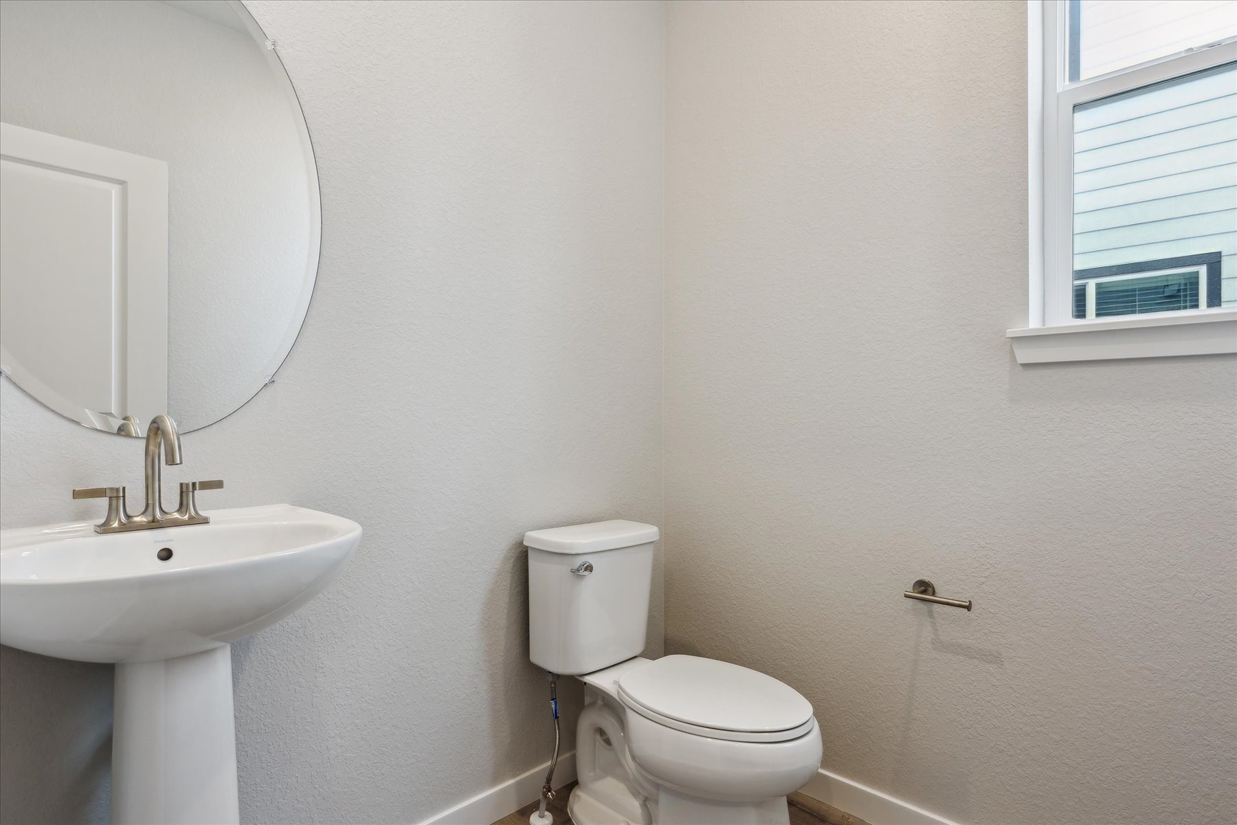 A bathroom with a toilet and sink.
