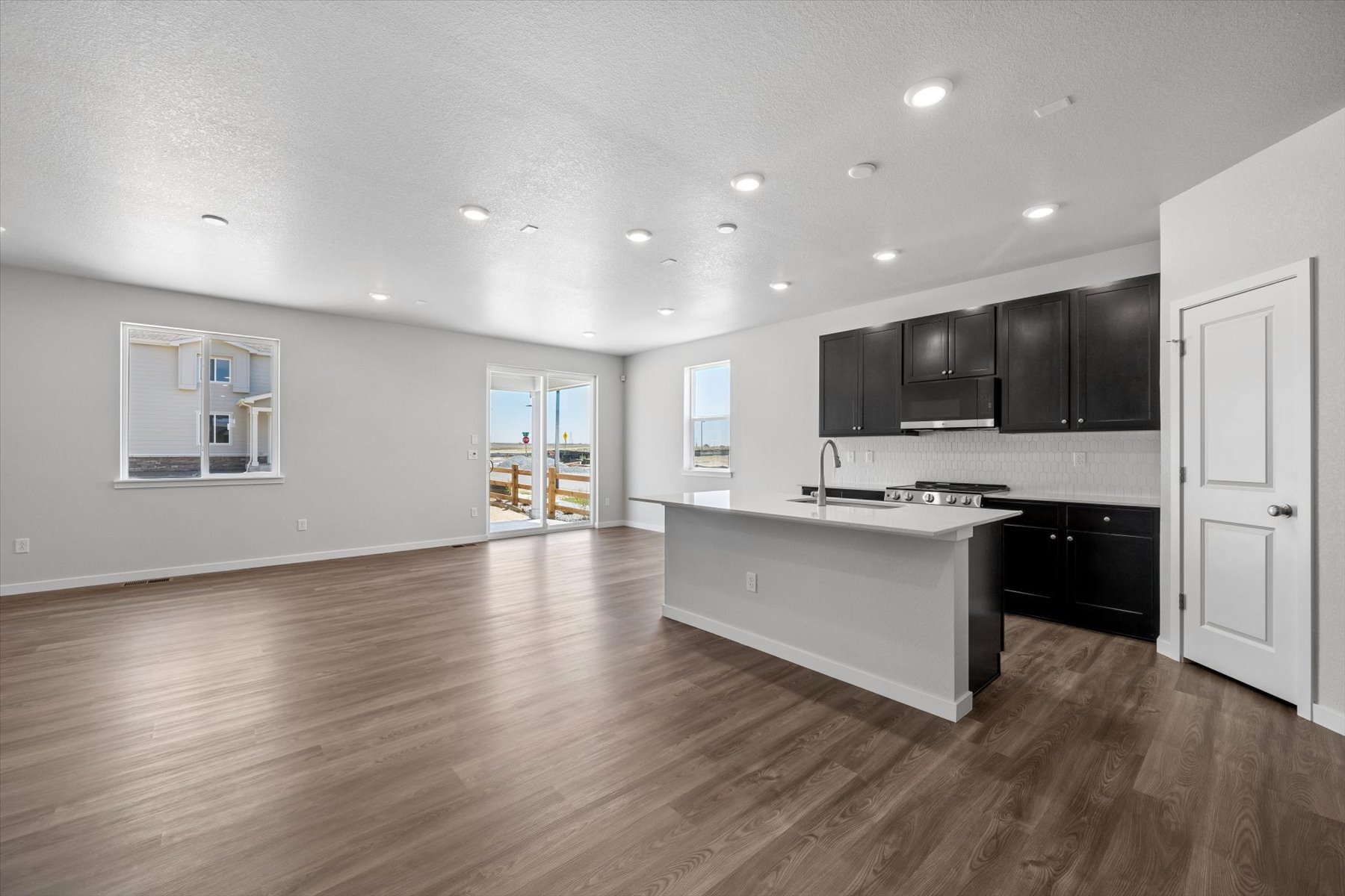 A large kitchen with black cabinets.
