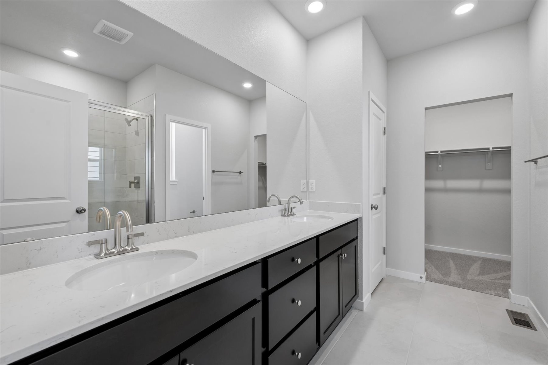 A bathroom with a large mirror.