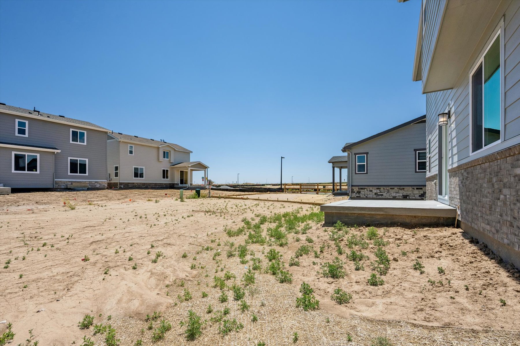 A dirt road between buildings.