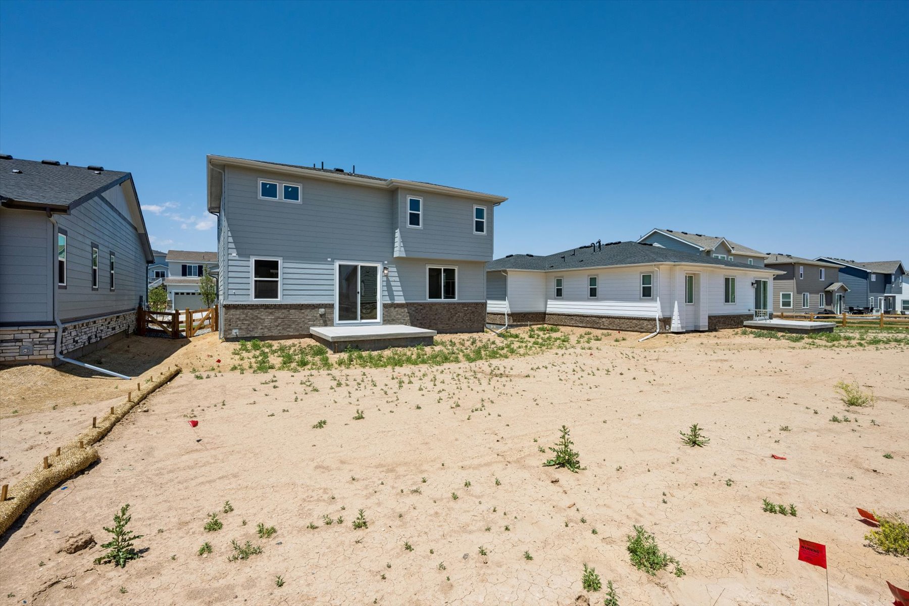A group of houses in a sandy area.