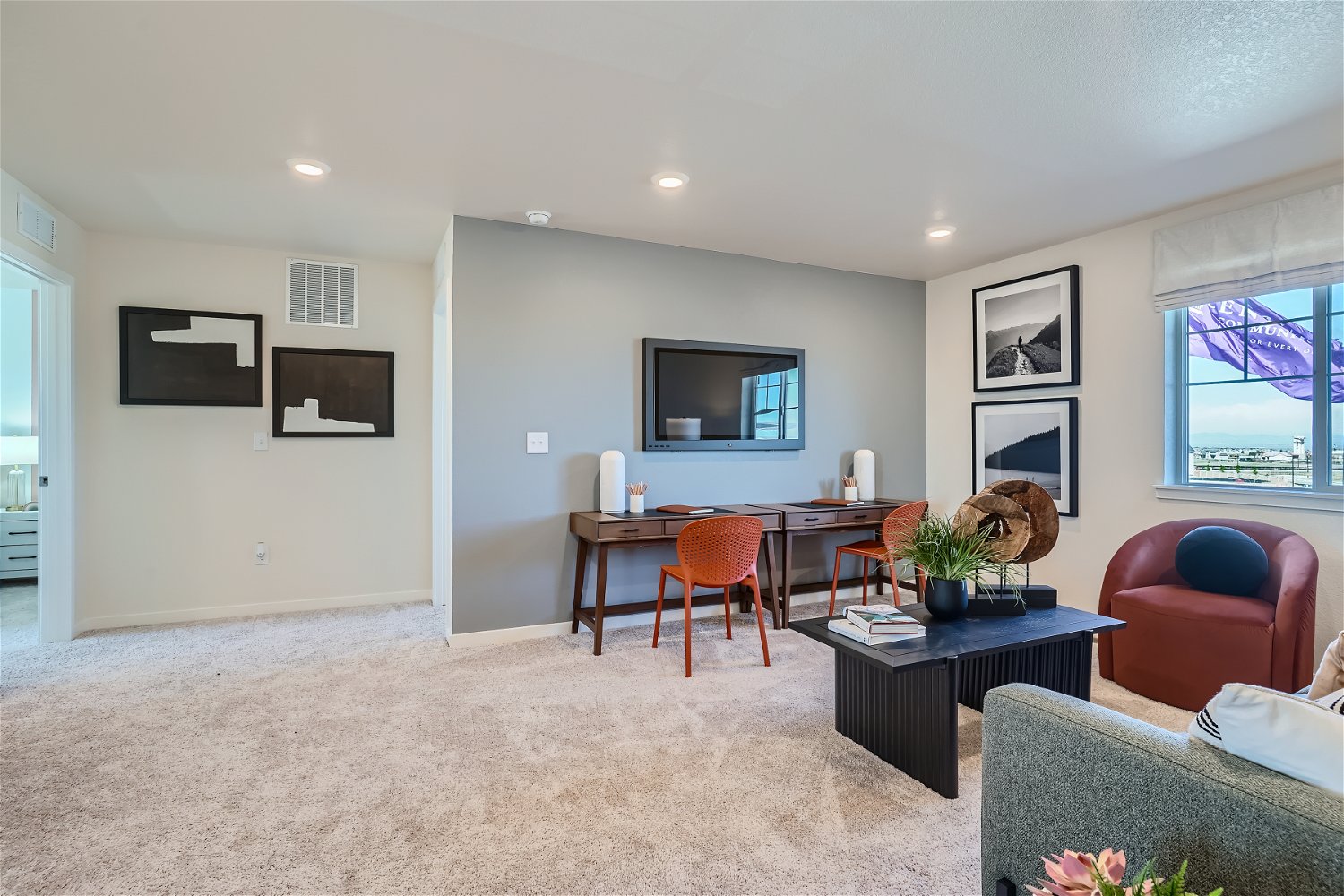 A living room with a tv and chairs.