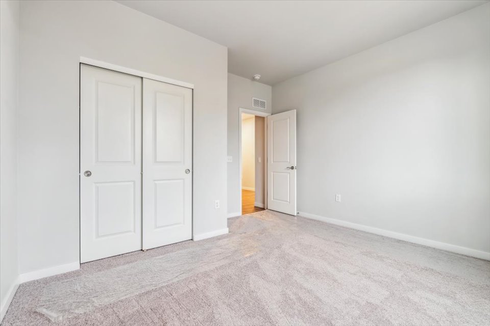 A hallway with white doors.
