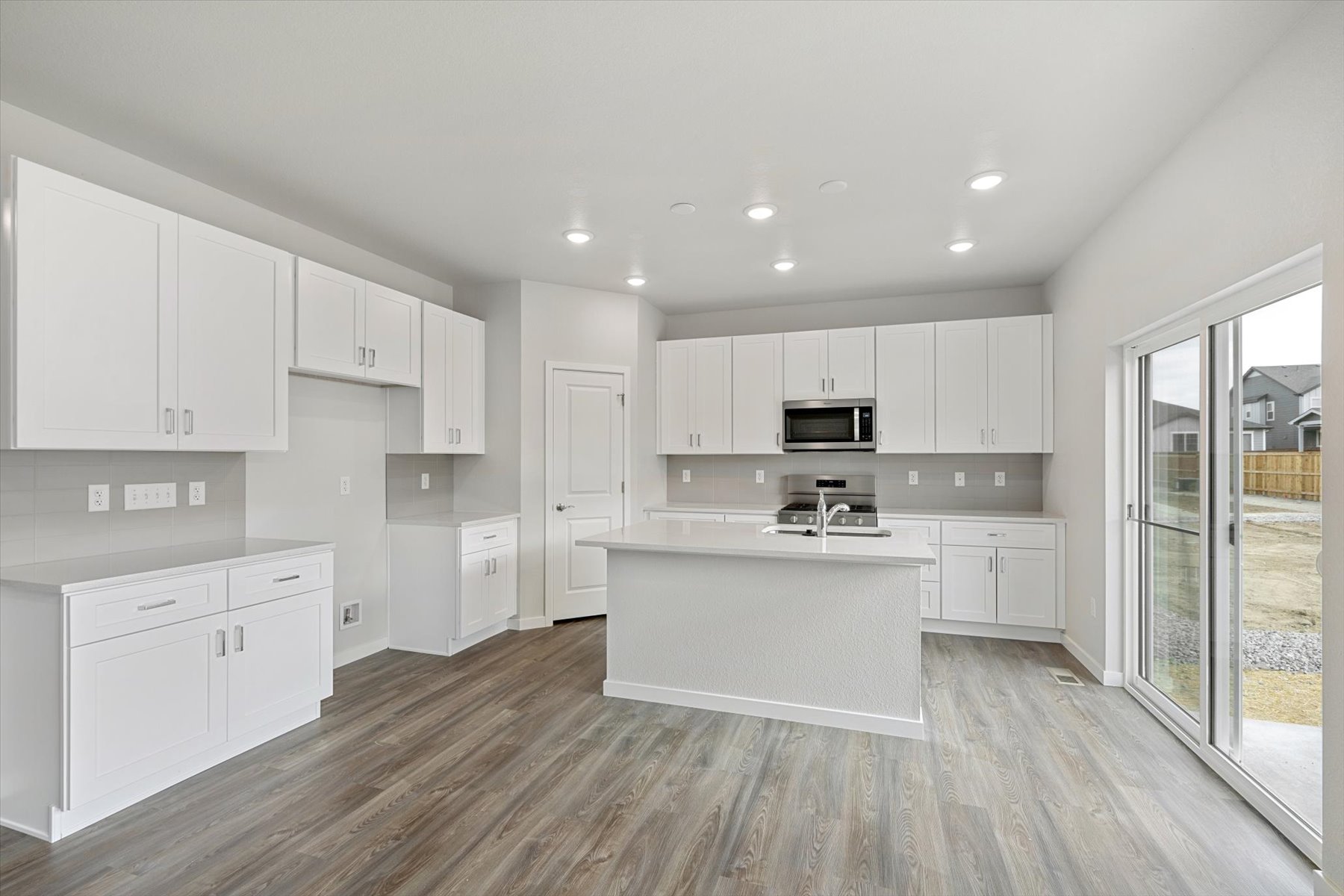 A kitchen with white cabinets.