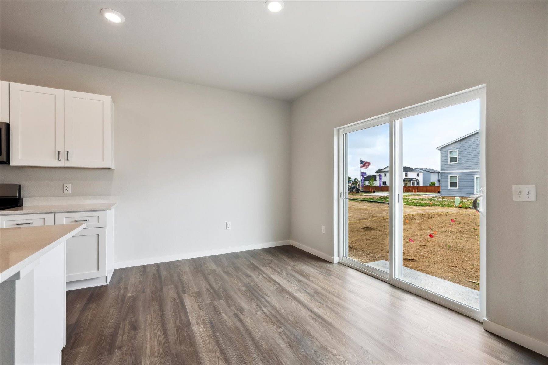 A room with a wood floor and a wood floor with a window.