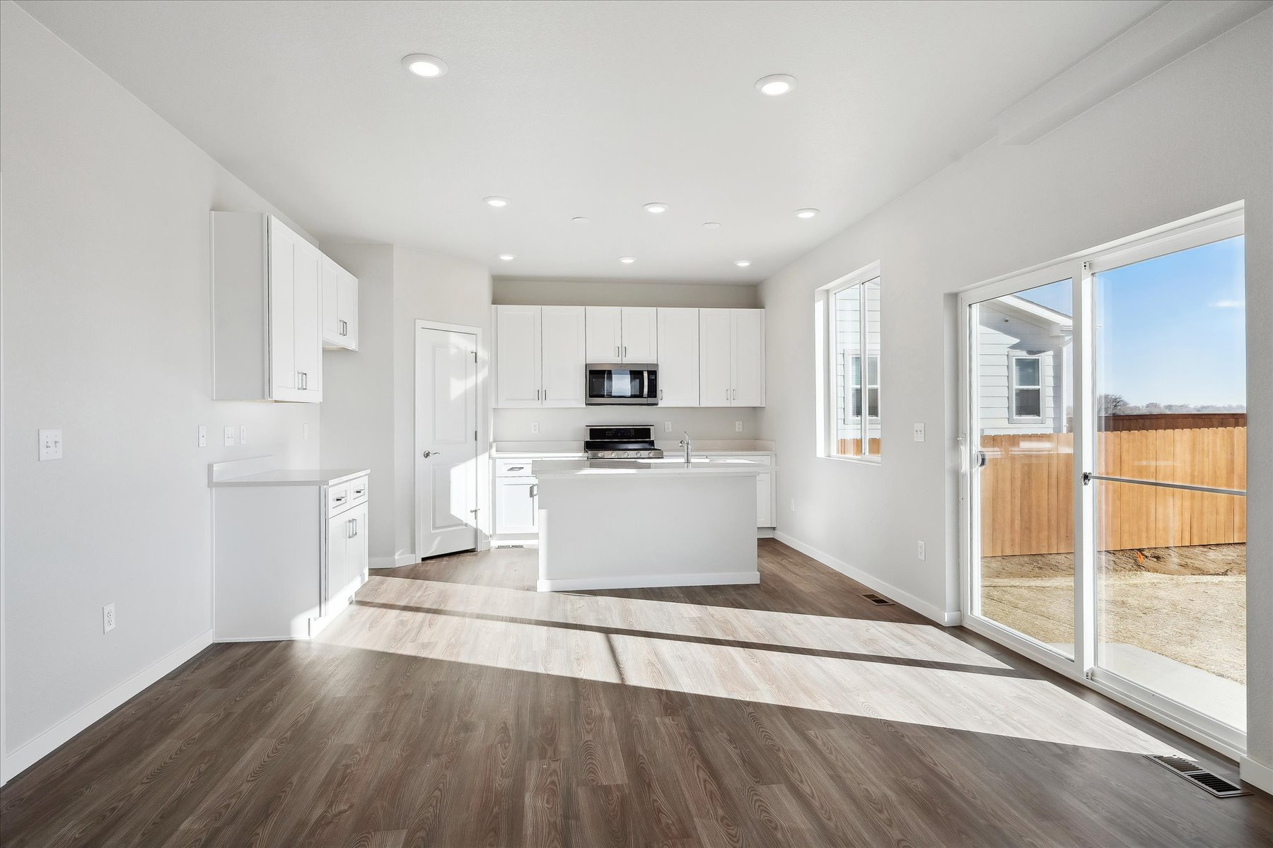 A large kitchen with white cabinets.