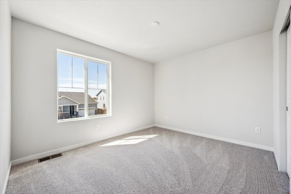 A room with a window and a carpet.