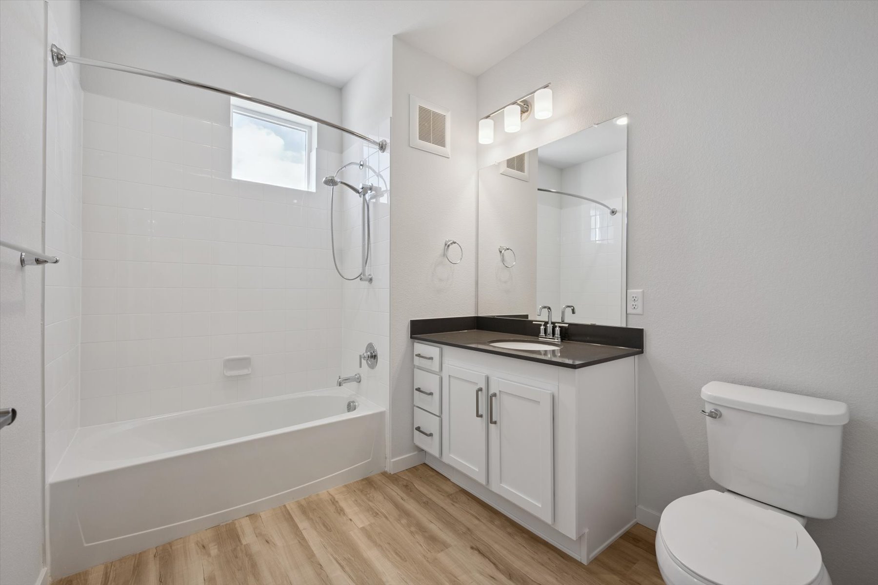 A bathroom with a tub toilet and sink.