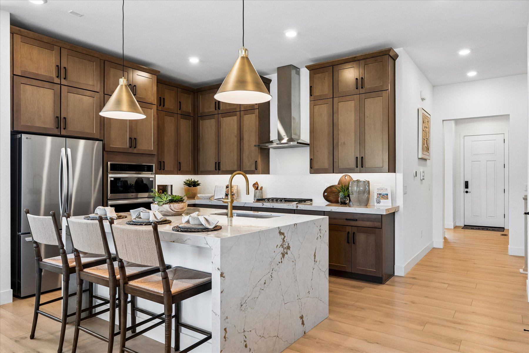 A kitchen with a dining table and a refrigerator.