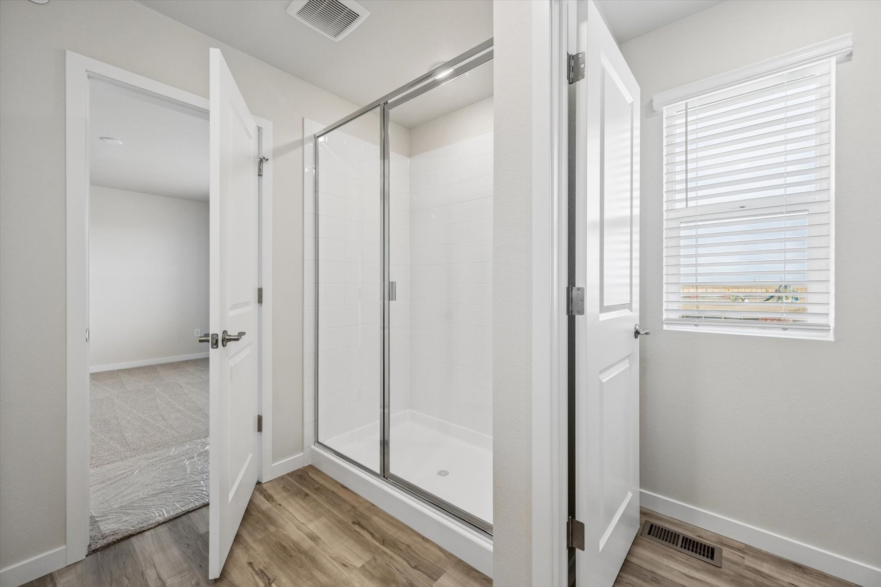 A shower with glass doors.