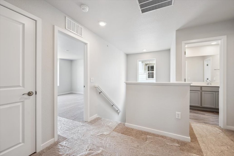 A room with white walls and a rug.