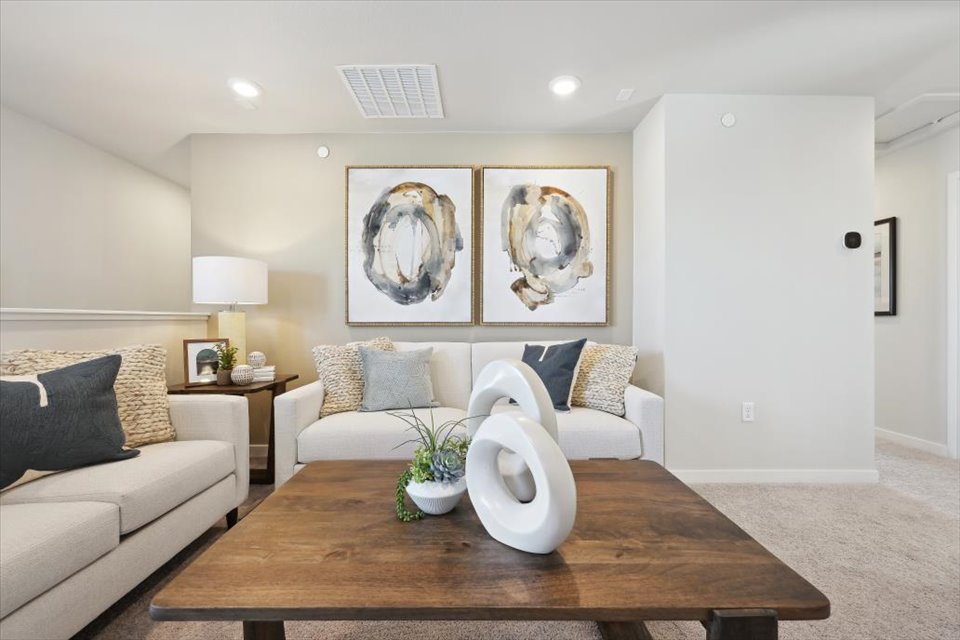 A living room with a table and couches.