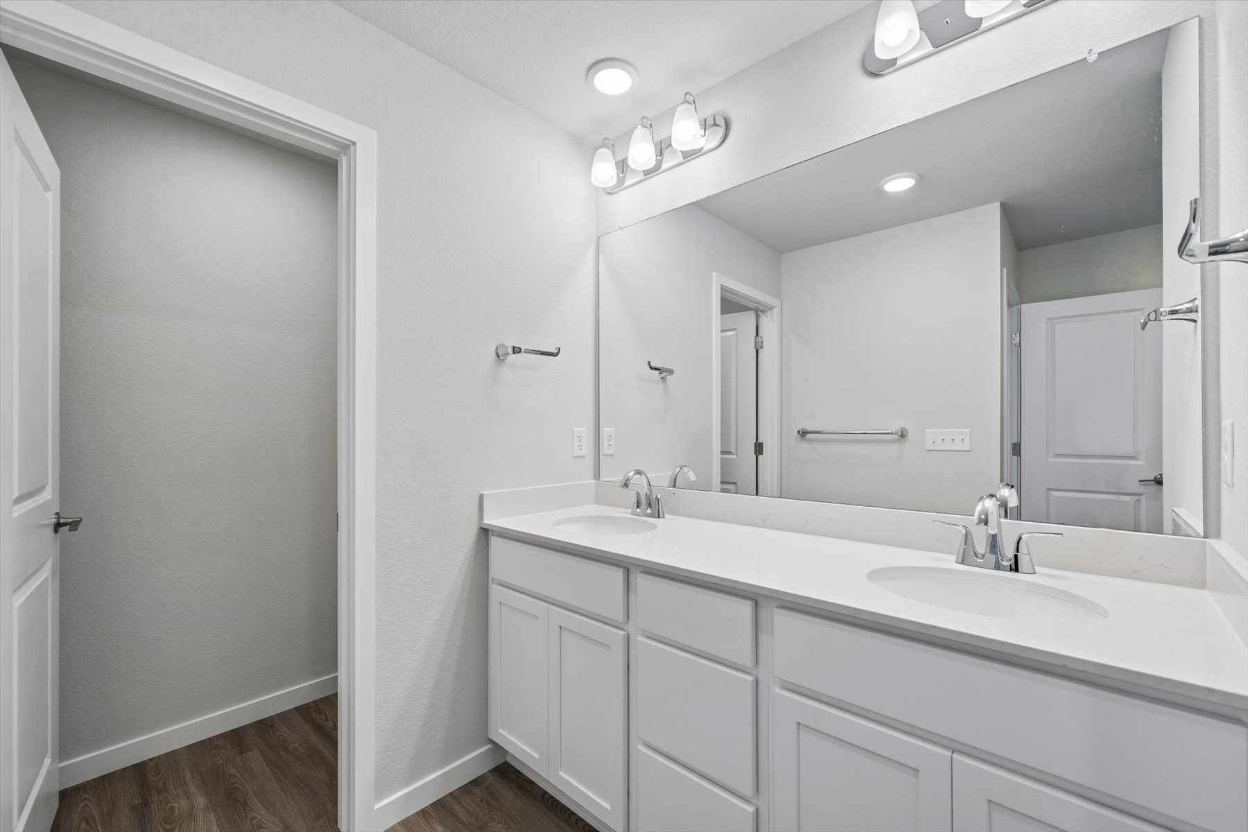 A bathroom with a large mirror.