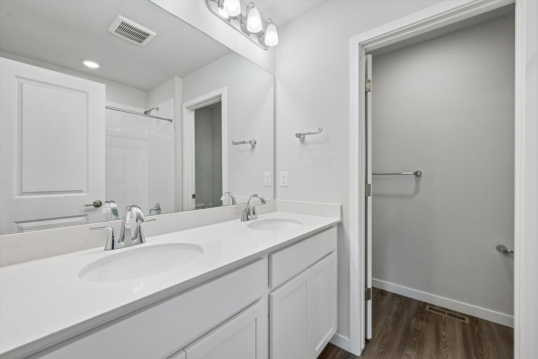 A bathroom with a sink and a shower unit.