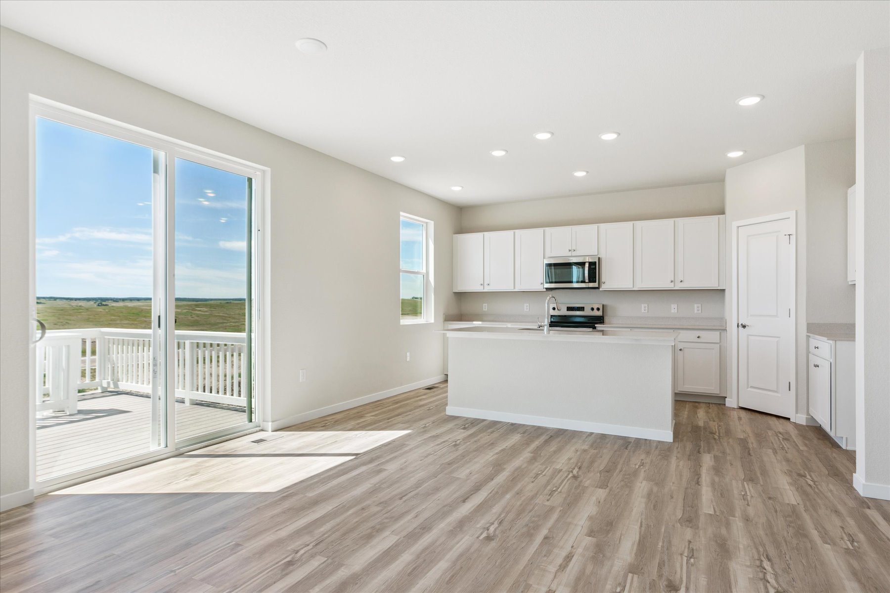 A kitchen with a large glass door.