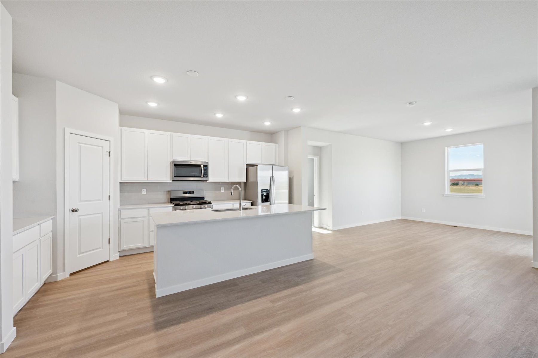 A large kitchen with white cabinets.